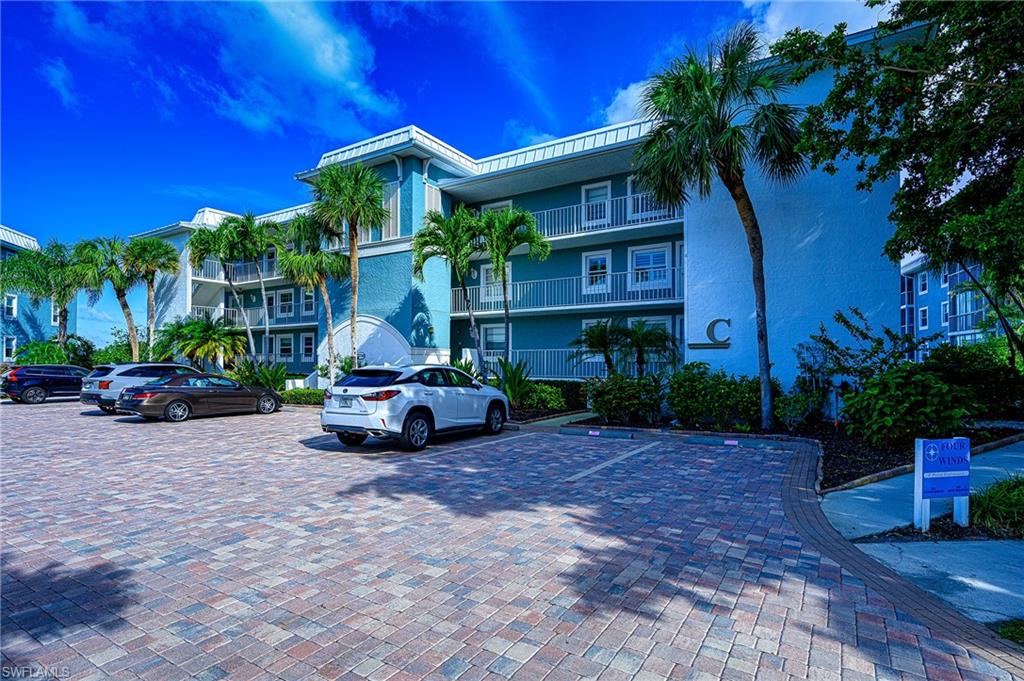 1280 Blue Point Avenue, Unit C30 Naples, FL 34102 - Photo 2 of 24 a front view of a house with a garden