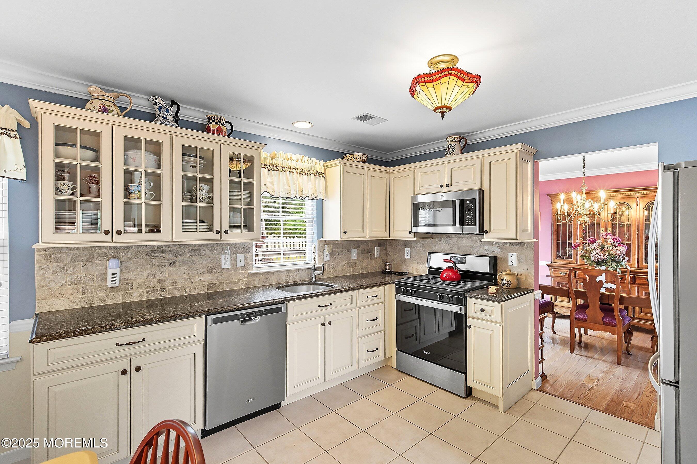 1990 Country Trace Toms River, NJ 08753 - Photo 9 of 33 a kitchen with stainless steel appliances granite countertop a stove and cabinets