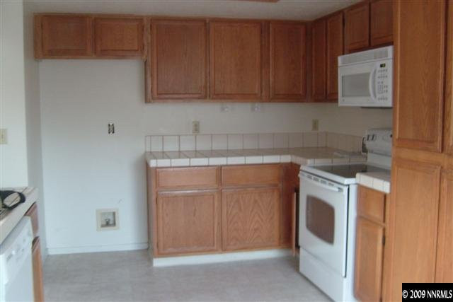 5140 Idlebury Way Reno, NV 89523 - Photo 4 of 9 a kitchen with stainless steel appliances granite countertop a sink and a cabinets