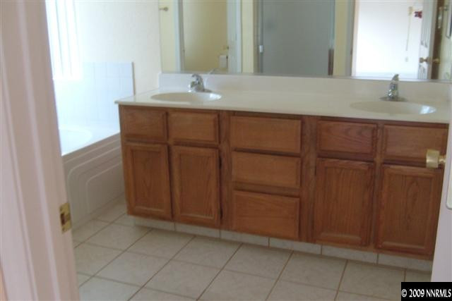 5140 Idlebury Way Reno, NV 89523 - Photo 7 of 9 a bathroom with a sink and a mirror