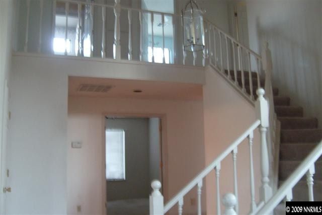 5140 Idlebury Way Reno, NV 89523 - Photo 8 of 9 a view of staircase with railing and a chandelier