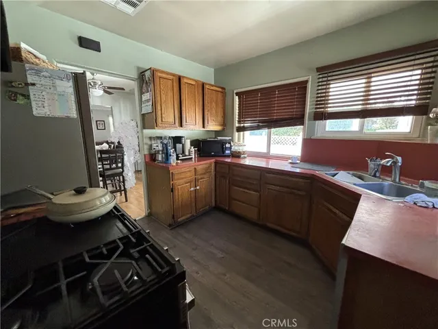 a kitchen with a stove a sink and a window