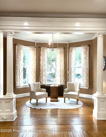 a living room with kitchen island furniture and floor to ceiling windows
