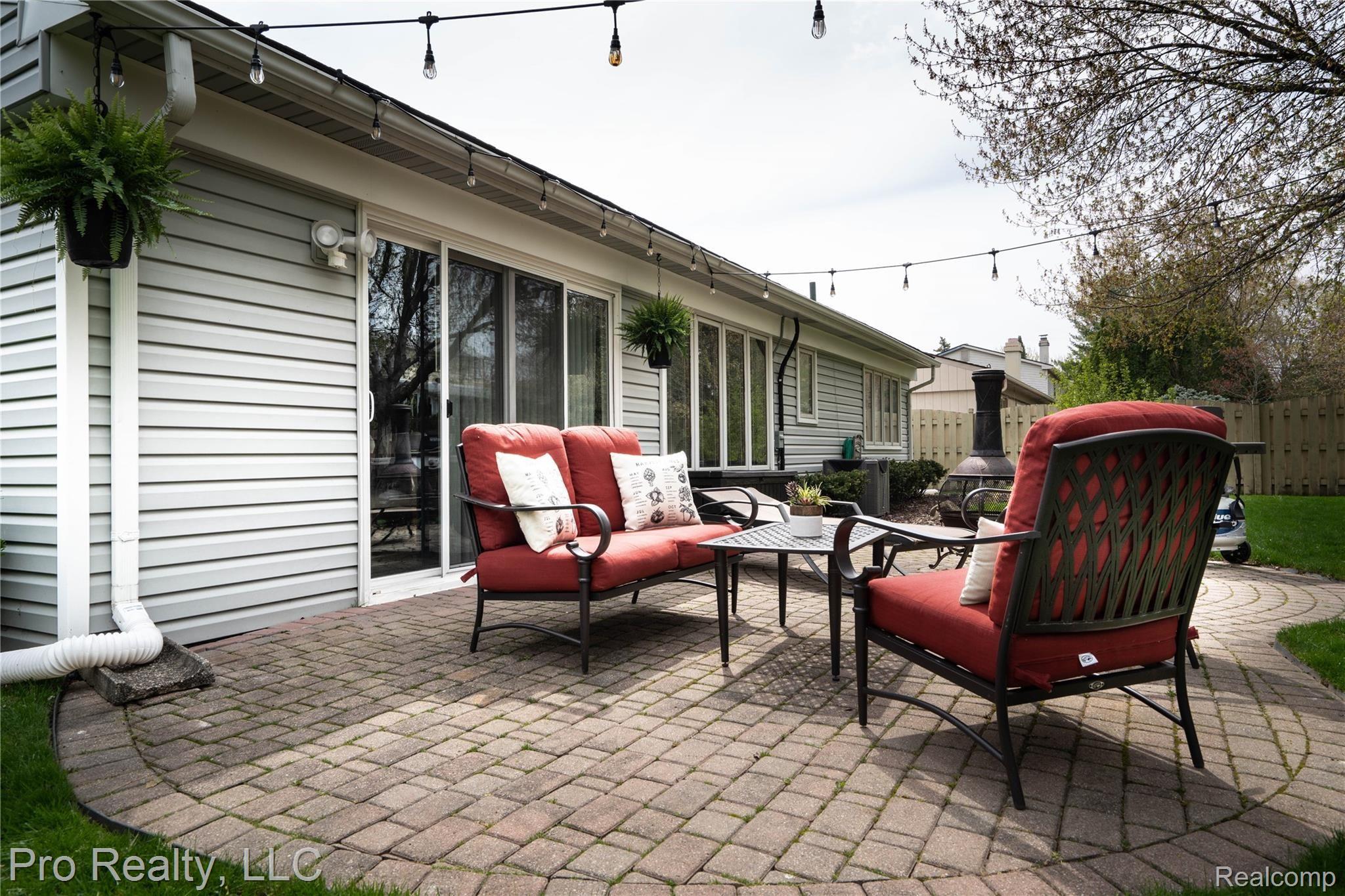 22697 Shadowpine Way Novi, MI 48375 - Photo 19 of 24 Patio with brick pavers and string lights