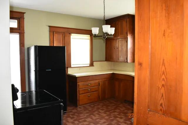 a kitchen with a refrigerator and a sink