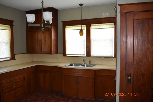a bathroom with a sink a mirror and a window