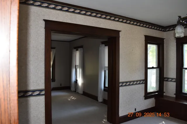 a view of a hallway with wooden floor and staircase