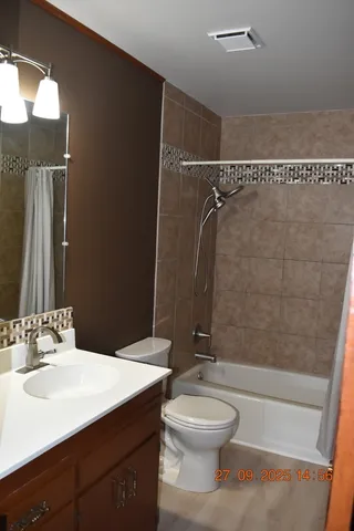 a bathroom with a toilet a sink and shower
