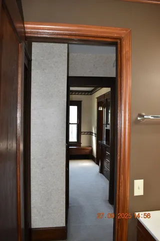 a view of a hallway with wooden shelves