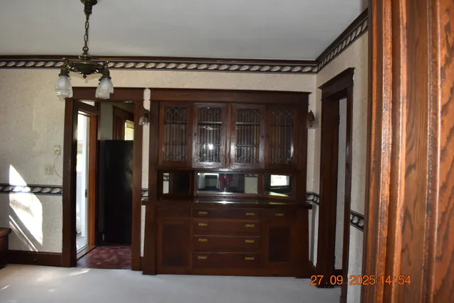 a view of a hallway with a mirror and furniture
