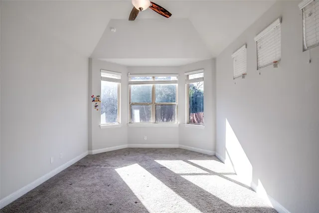 a view of a livingroom with a ceiling fan and window