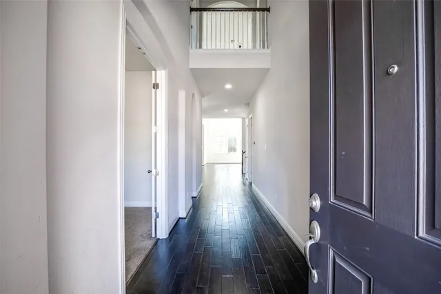 a view of hallway with wooden floor