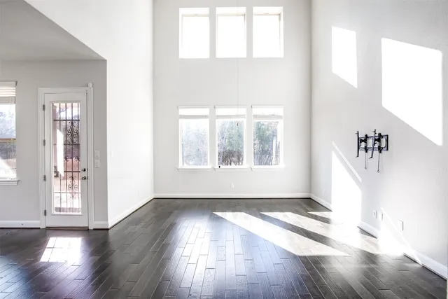 a view of a living room and kitchen with furniture wooden floor and windows