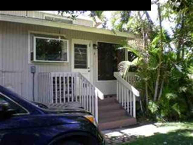 a view of a porch with furniture and garden