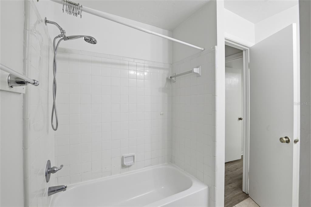 2219 Southwest 39th Way Gainesville, FL 32607 - Photo 12 of 17 a bathroom with a bathtub and a shower