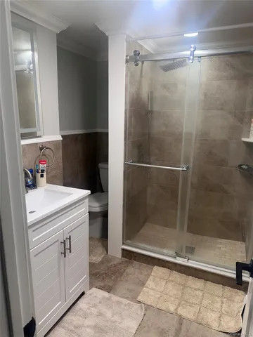 a bathroom with a shower toilet and sink