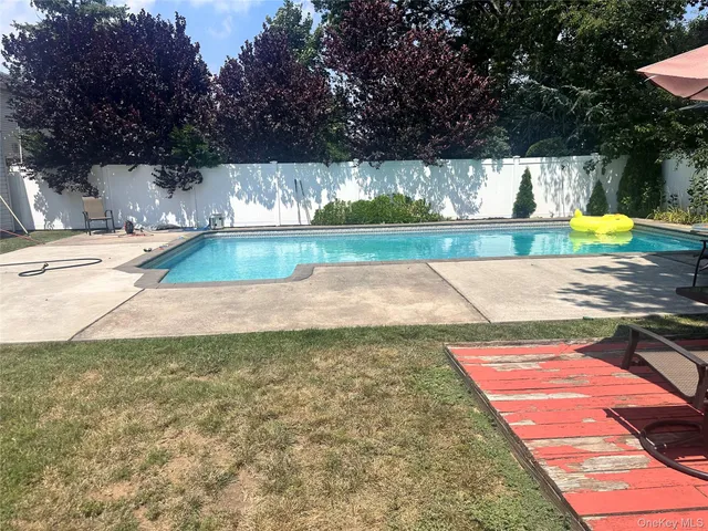 a view of a backyard with swimming pool