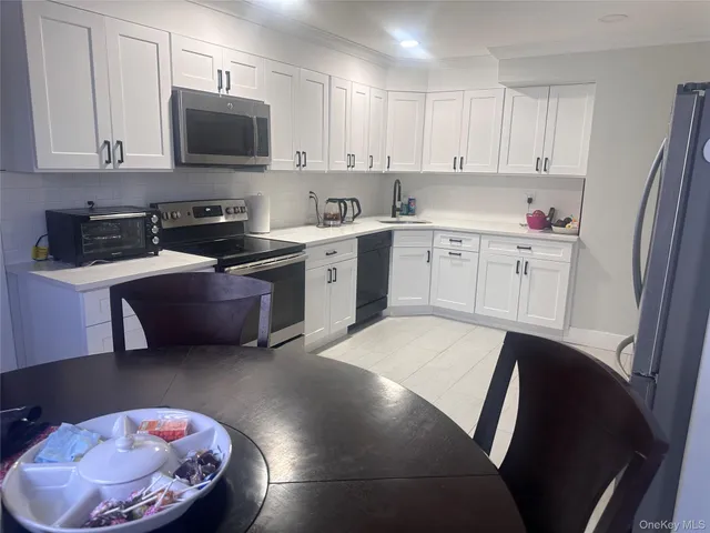 a kitchen with a sink a stove and cabinets