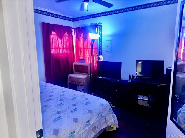 a bedroom with a bed with red walls and furniture