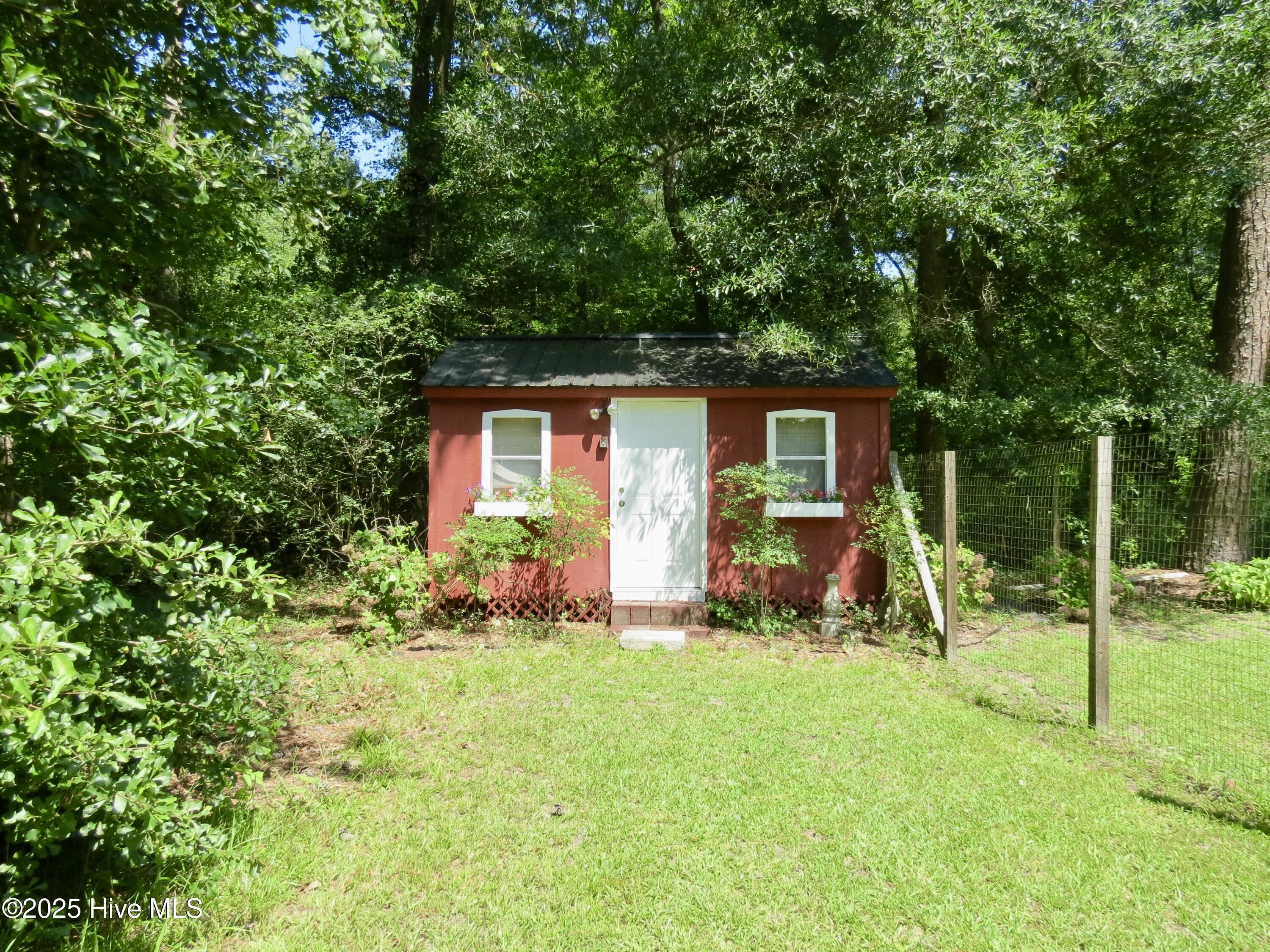 232 Tiptoe Road Edenton, NC 27932 - Photo 19 of 32 Office/workspace with metal roof. Notice the LARGE fenced in back yard with multiple gates all the way around.