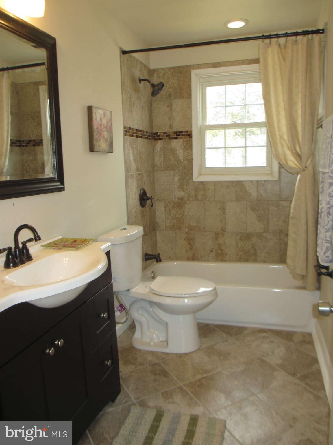 6600 Poplar Road Morningside, MD 20746 - Photo 13 of 13 a bathroom with a sink toilet and shower
