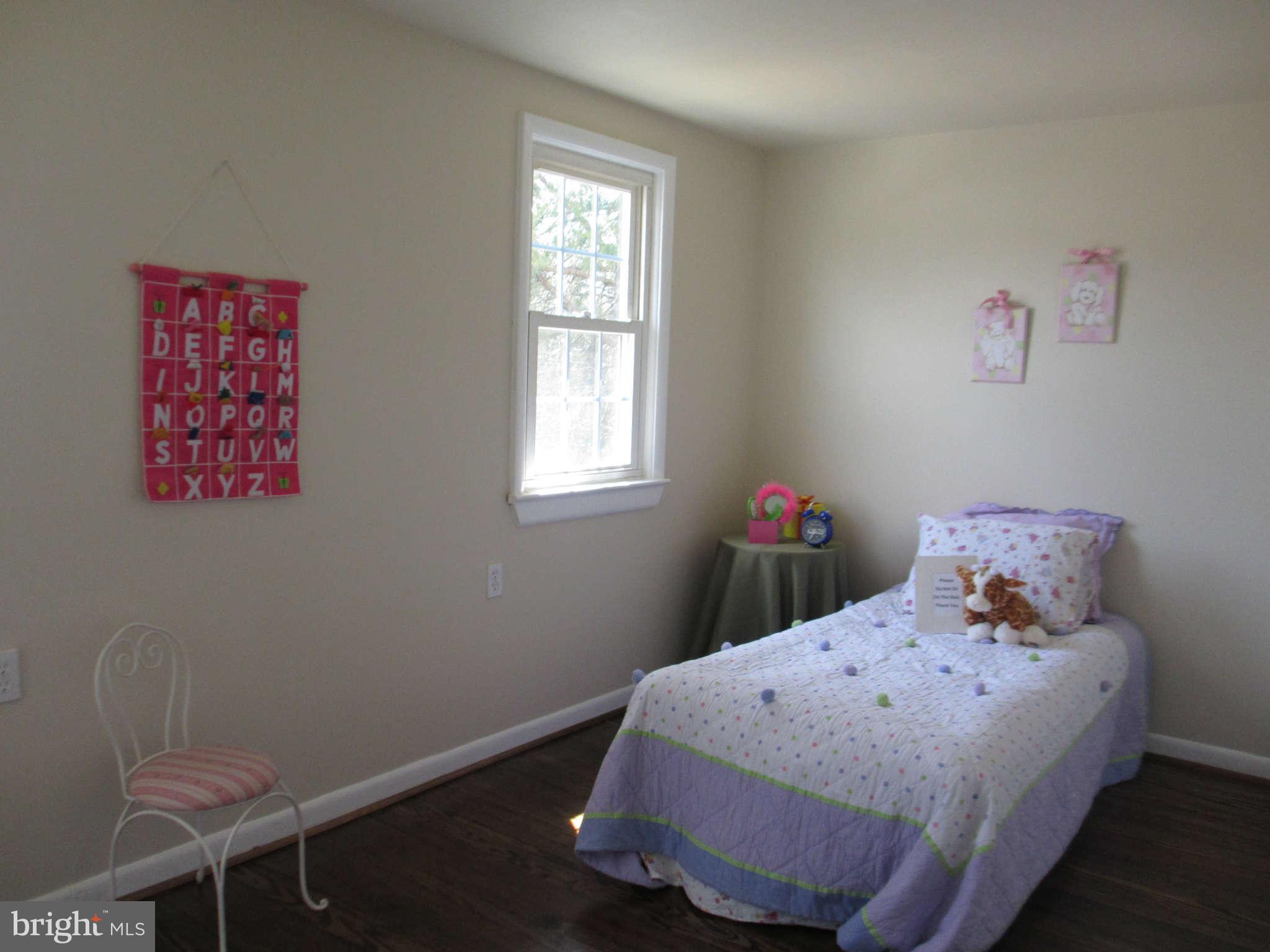 6600 Poplar Road Morningside, MD 20746 - Photo 6 of 13 a bed sitting in a bedroom next to a window