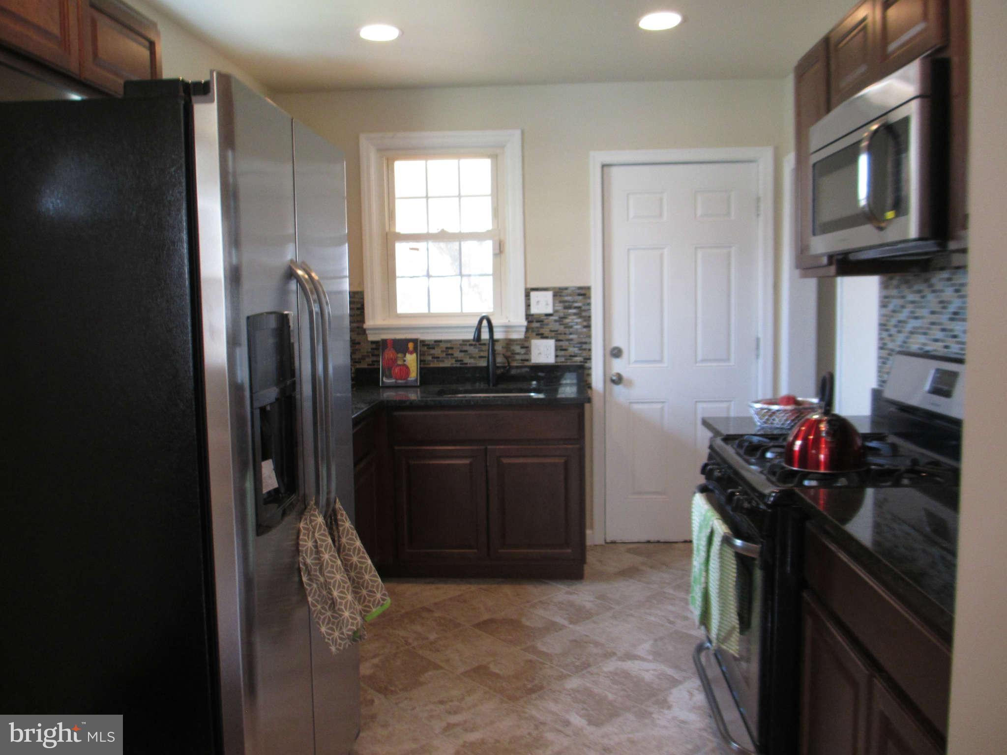 6600 Poplar Road Morningside, MD 20746 - Photo 10 of 13 a kitchen with a refrigerator and a sink