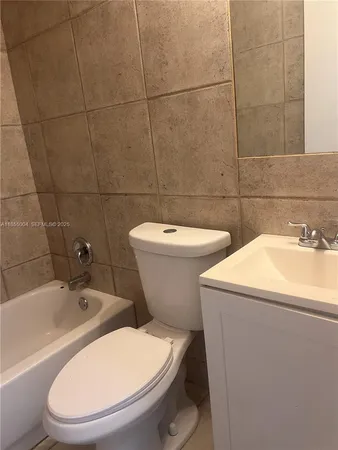 a bathroom with a toilet a sink and bathtub
