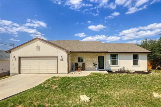a front view of house with yard and green space