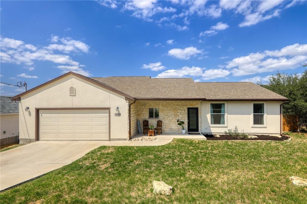 a front view of house with yard and green space
