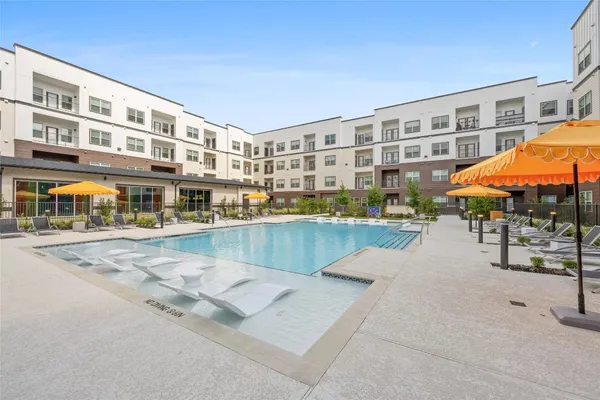 a swimming pool with outdoor seating and yard