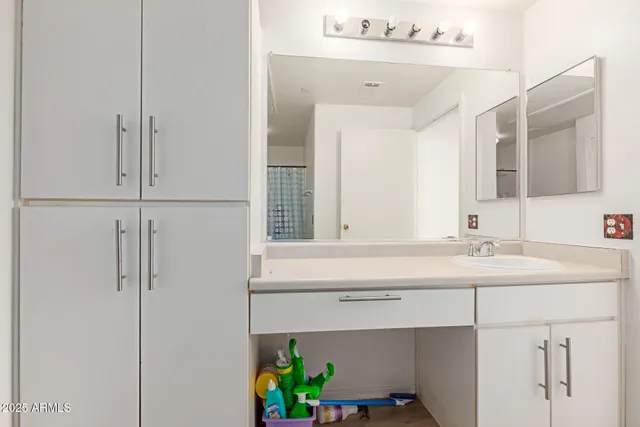 a bathroom with a sink and a mirror
