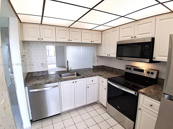 a kitchen with stainless steel appliances granite countertop a stove and a microwave
