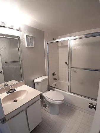 a bathroom with a sink toilet and mirror