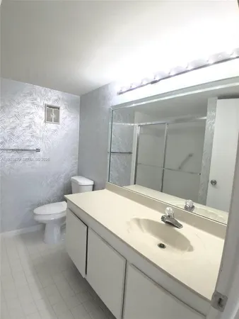 an empty room with windows and painted walls