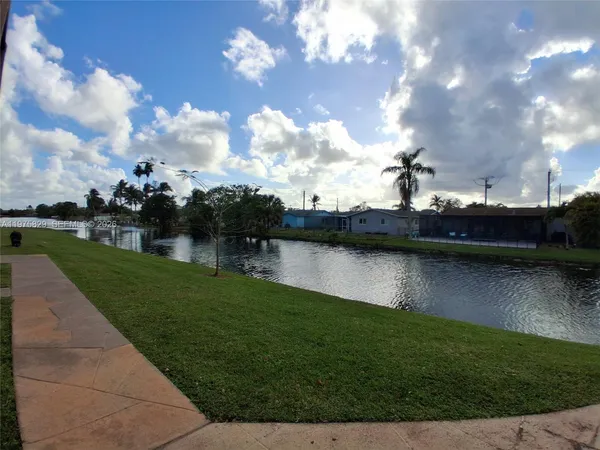 a view of a backyard with plants and outdoor space