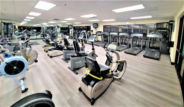 a living room with patio furniture and a floor to ceiling window