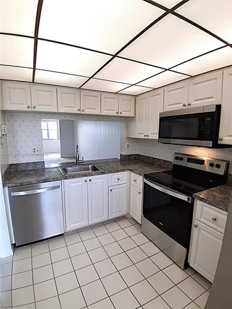 an empty room with a window and a ceiling fan