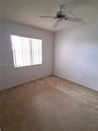 a view of a room with a ceiling fan