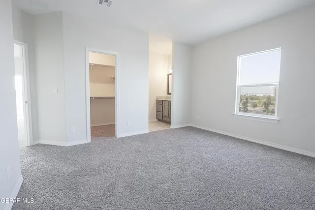 an empty room with windows and closet