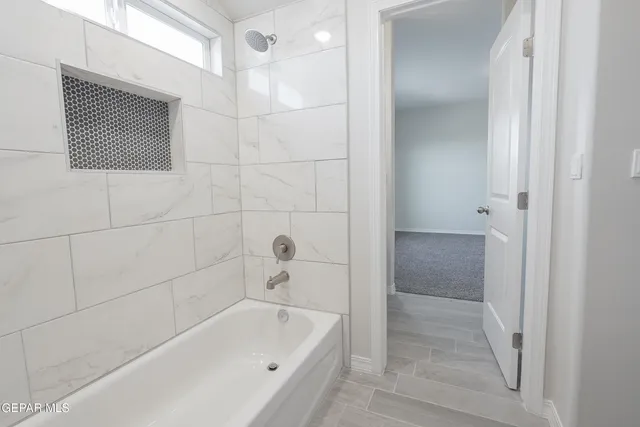 a bathroom with a bathtub and shower