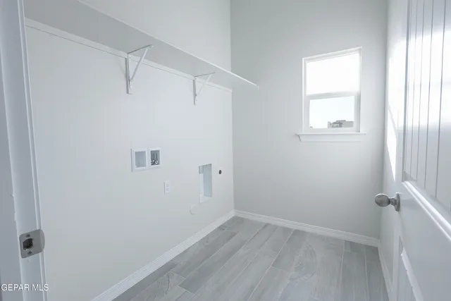 a view of a small space with wooden floor and a window