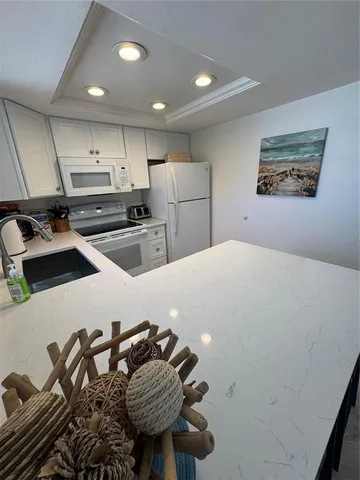 a kitchen with a sink and appliances