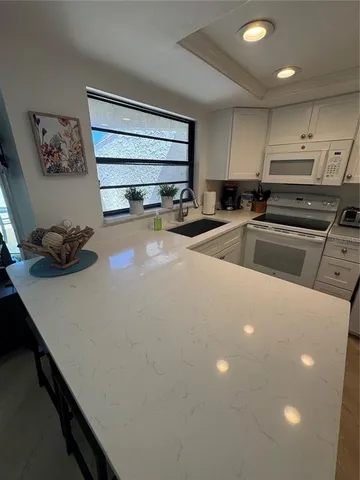 a kitchen that has a sink and a stove