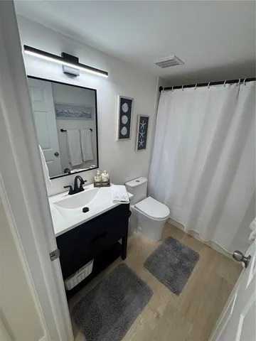 a bedroom with two beds and painting on the wall