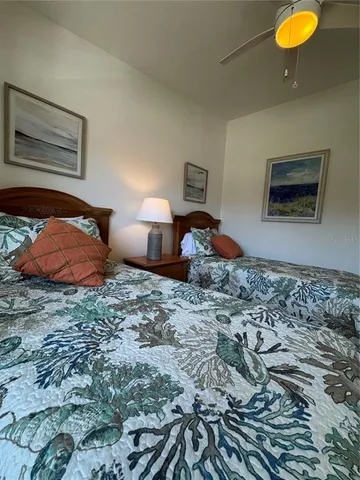 a bedroom with two beds and painting on the wall