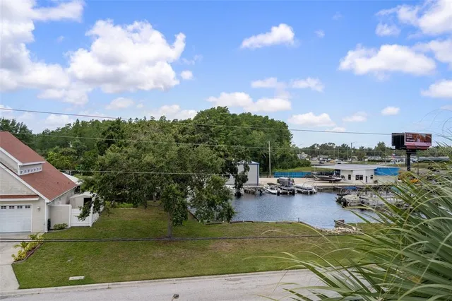 a view of a house with swimming pool and sitting area