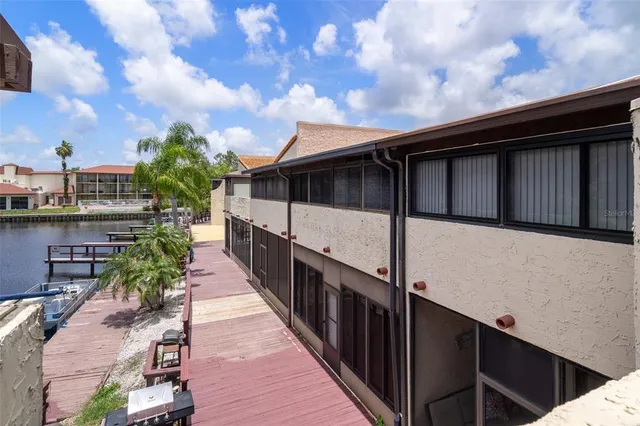 a front view of a house with a yard and potted plants