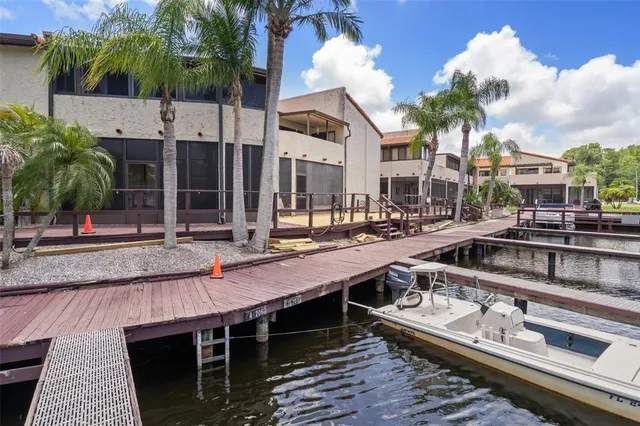 a view of swimming pool with outdoor seating and lake