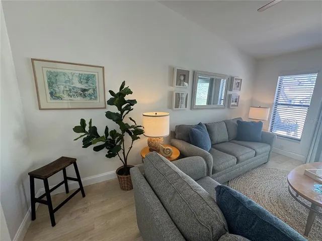 a living room with furniture and a potted plant
